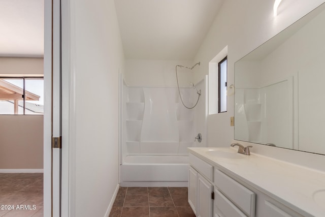 bathroom featuring vanity, tub / shower combination, and tile patterned flooring