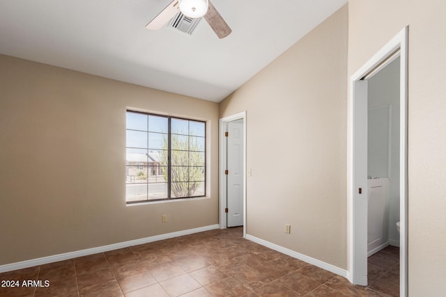 unfurnished bedroom with ceiling fan and vaulted ceiling