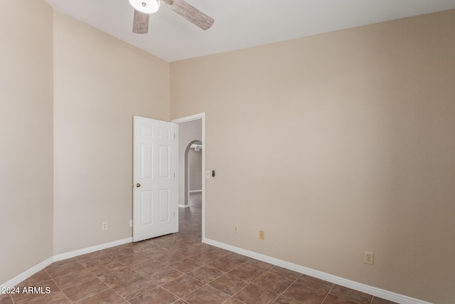 tiled empty room with ceiling fan