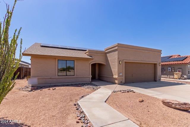 view of front of home featuring a garage and solar panels