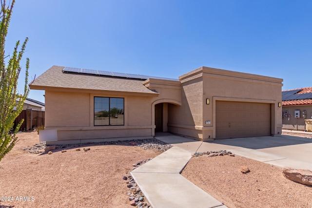 view of front of home with a garage and solar panels