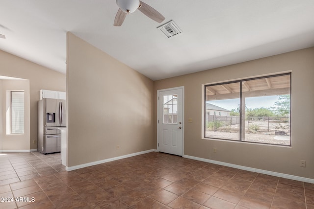 tiled foyer with lofted ceiling and ceiling fan