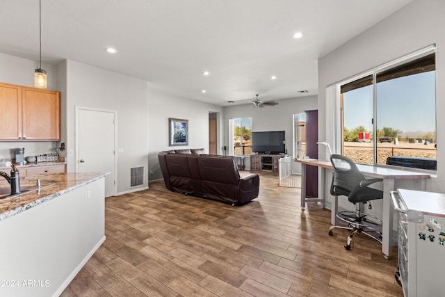 living room with ceiling fan and sink