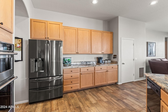 kitchen featuring light stone counters, light brown cabinets, dishwasher, stainless steel fridge with ice dispenser, and dark hardwood / wood-style floors