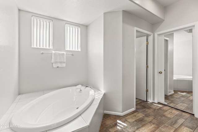 bathroom featuring tiled tub