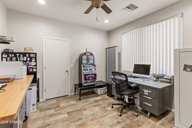 home office featuring light hardwood / wood-style floors and ceiling fan