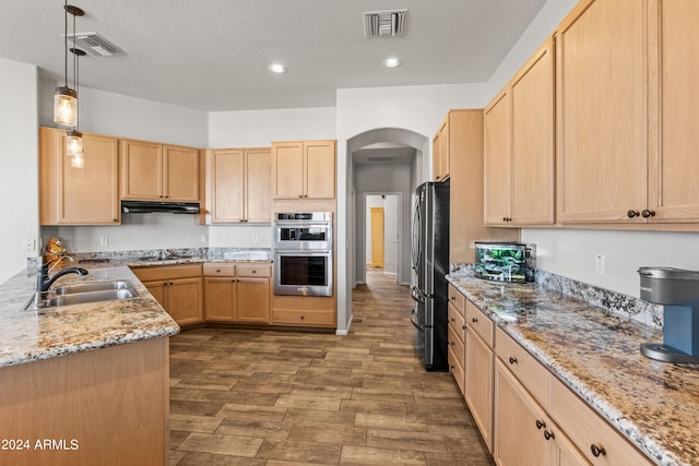 kitchen with pendant lighting, sink, stainless steel appliances, and light brown cabinetry