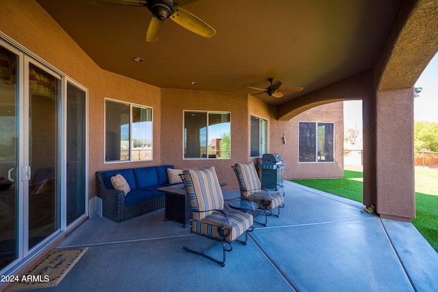 view of patio featuring area for grilling, ceiling fan, and an outdoor living space