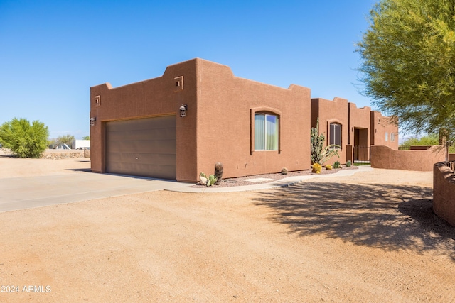 pueblo-style house with a garage