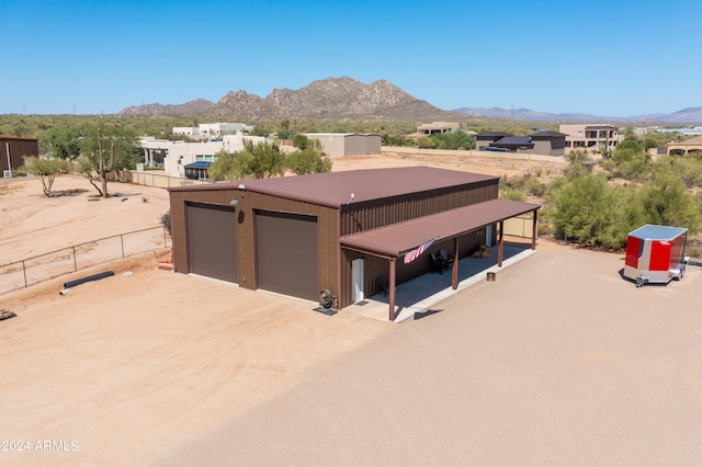 view of front of property featuring a mountain view and an outbuilding