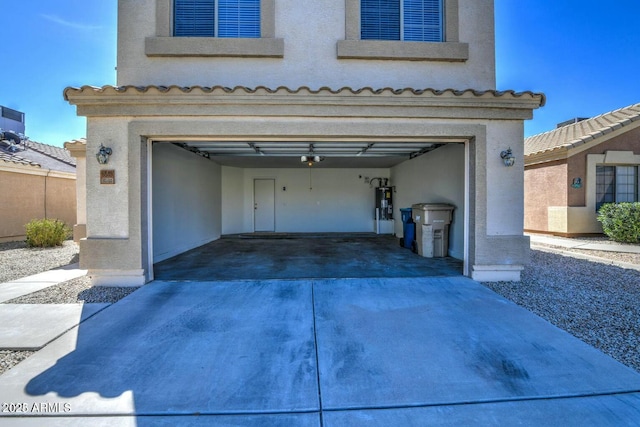 garage featuring a garage door opener and water heater