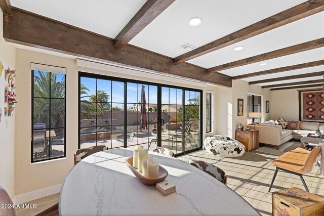 bedroom with beamed ceiling and hardwood / wood-style floors