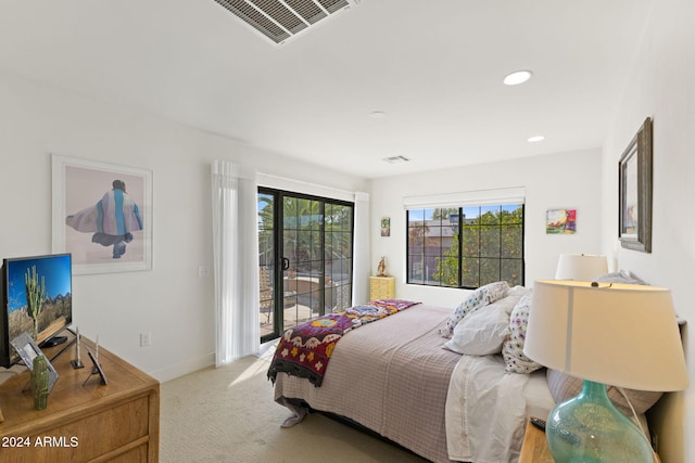 bedroom featuring access to exterior and carpet