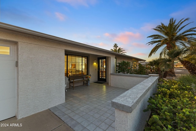 view of patio terrace at dusk