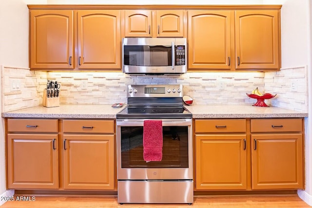 kitchen featuring appliances with stainless steel finishes and backsplash