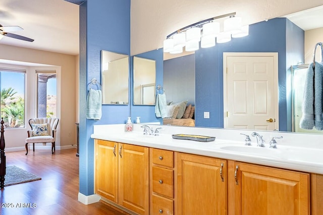 bathroom with hardwood / wood-style floors, vanity, and ceiling fan