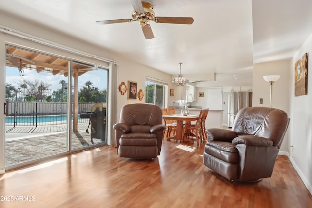 living room featuring ceiling fan and light hardwood / wood-style flooring