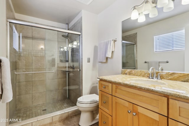 bathroom with tile patterned floors, vanity, toilet, and a shower with door