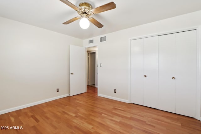 unfurnished bedroom with a closet, light hardwood / wood-style flooring, and ceiling fan