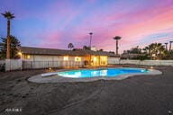 view of pool at dusk