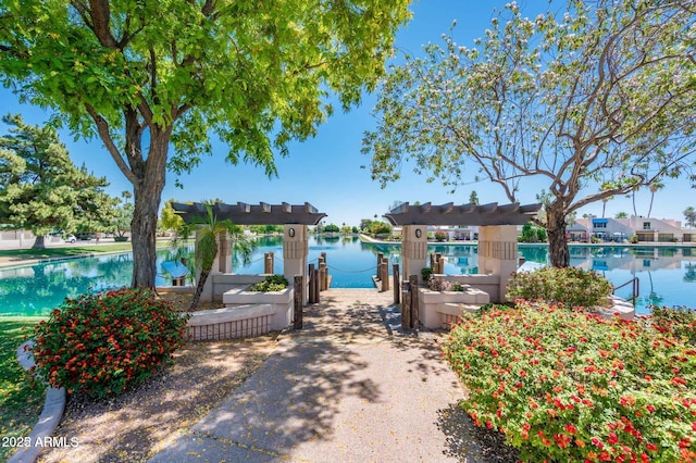 exterior space with a pergola and a water view