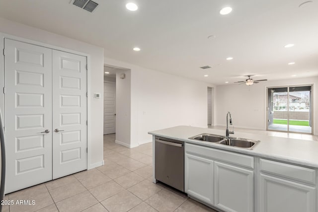 kitchen with sink, light tile patterned flooring, white cabinetry, ceiling fan, and stainless steel dishwasher