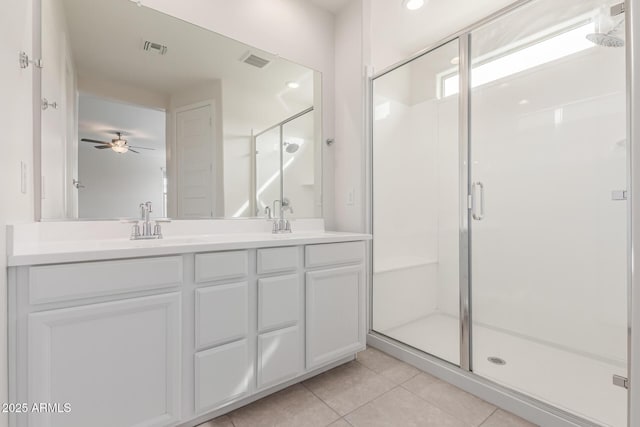 bathroom with tile patterned floors, vanity, and walk in shower