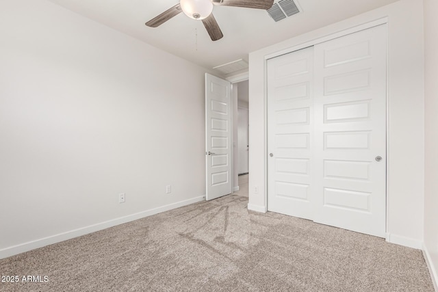 unfurnished bedroom with a closet, ceiling fan, and carpet flooring