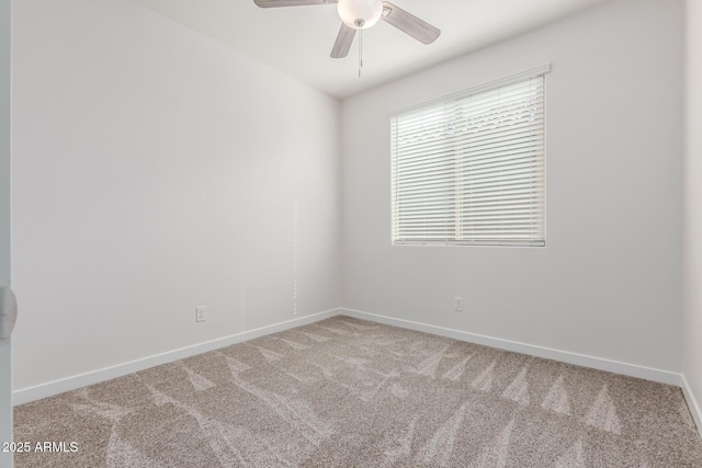 spare room featuring ceiling fan and carpet