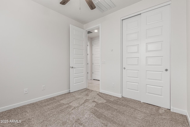 unfurnished bedroom with a closet and light colored carpet