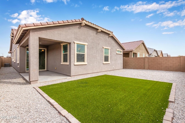 back of house featuring a yard and a patio area