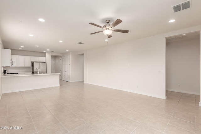 unfurnished living room with ceiling fan