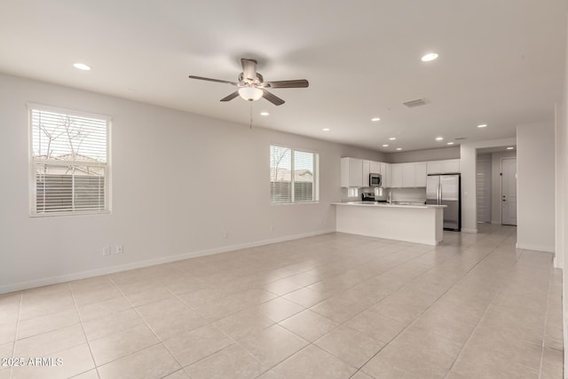 unfurnished living room with ceiling fan and light tile patterned floors