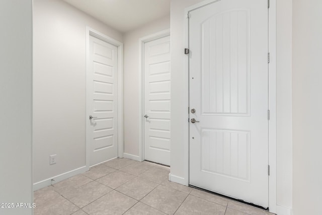 entryway with light tile patterned floors