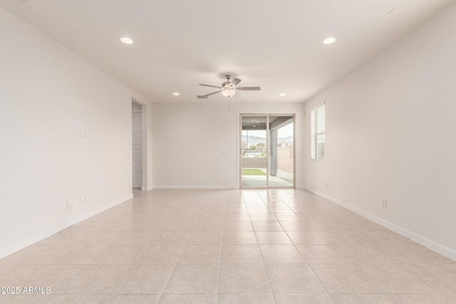 unfurnished room with light tile patterned floors and ceiling fan