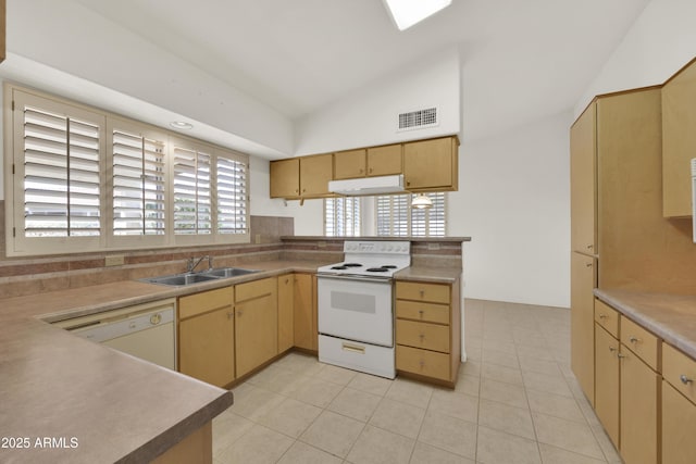 kitchen featuring vaulted ceiling, sink, light tile patterned floors, and white appliances