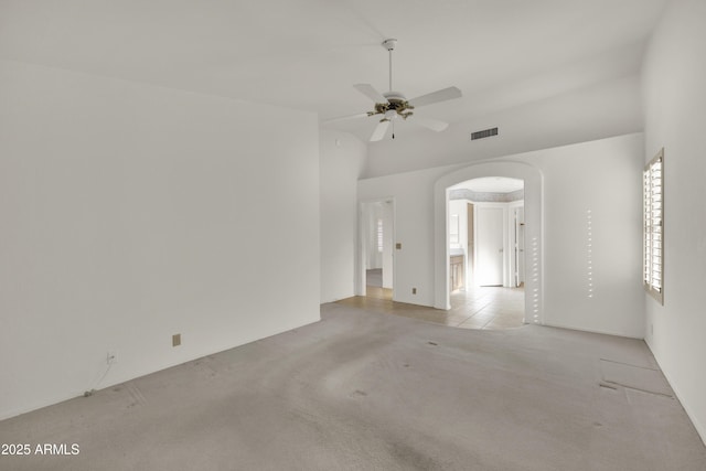 carpeted spare room featuring high vaulted ceiling and ceiling fan