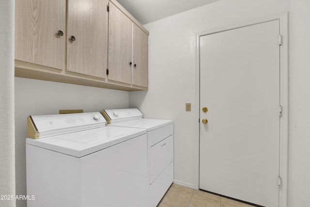 laundry area with cabinets, independent washer and dryer, and light tile patterned flooring