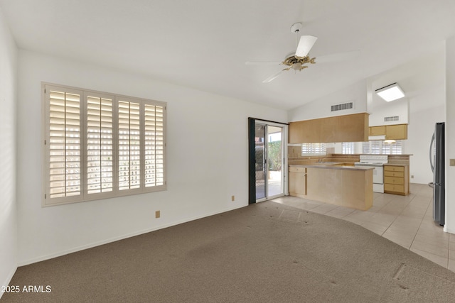 unfurnished living room with ceiling fan, lofted ceiling, and light carpet