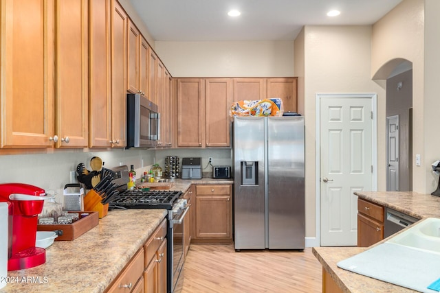 kitchen featuring appliances with stainless steel finishes, recessed lighting, light countertops, and light wood-style floors