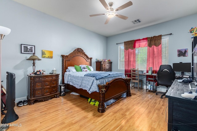 bedroom with visible vents, ceiling fan, baseboards, and wood finished floors