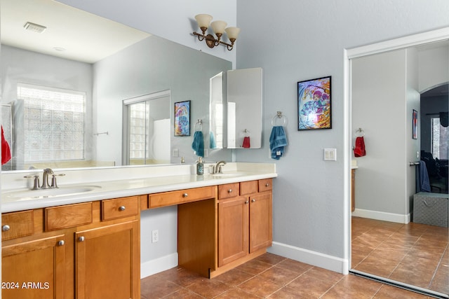 bathroom with dual bowl vanity and tile patterned flooring