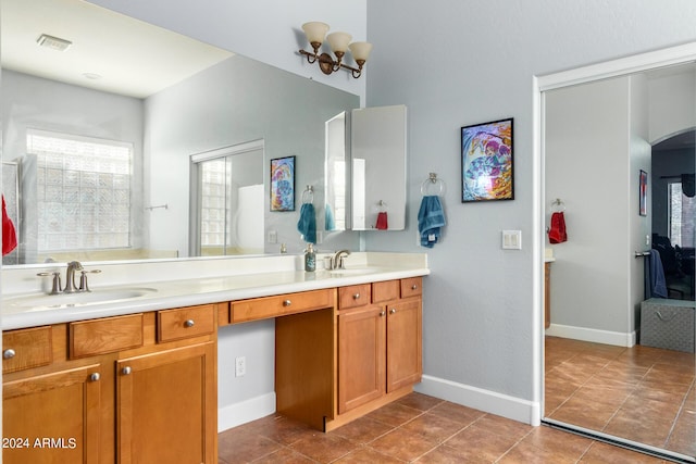 full bath featuring double vanity, tile patterned flooring, visible vents, and a sink