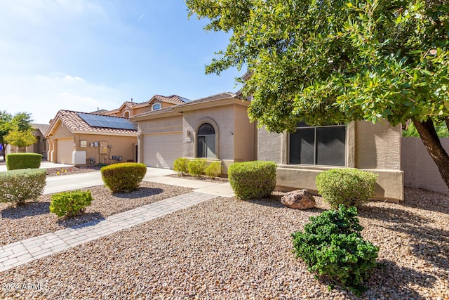 view of front of home featuring an attached garage, concrete driveway, and stucco siding