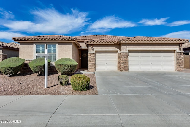 9952 W Jessie Ln, Peoria, AZ 85383 - view of front of home featuring a garage, stucco siding, stone siding, and concrete driveway