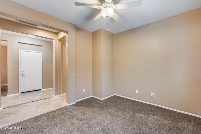9952 W Jessie Ln, Peoria, AZ 85383 - tiled empty room with ceiling fan, baseboards, and carpet flooring