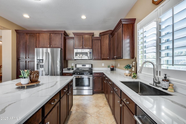 9952 W Jessie Ln, Peoria, AZ 85383 - kitchen featuring stainless steel appliances, a sink, light stone counters, recessed lighting, and light tile patterned floors