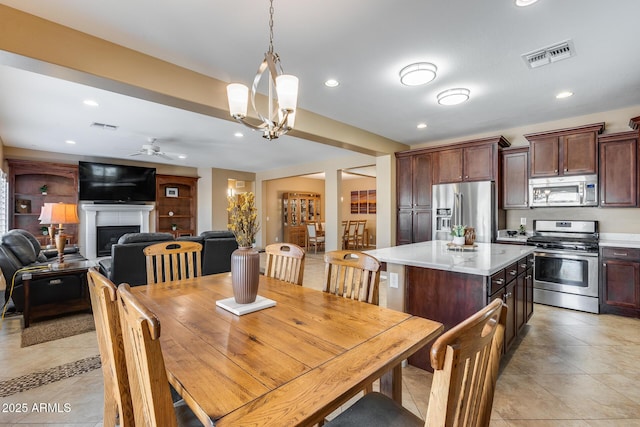 9952 W Jessie Ln, Peoria, AZ 85383 - dining room with recessed lighting, a fireplace, ceiling fan, and light tile patterned floors