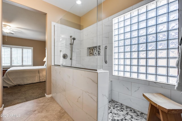 9952 W Jessie Ln, Peoria, AZ 85383 - ensuite bathroom featuring a walk in shower, ceiling fan, tile patterned flooring, and tile walls