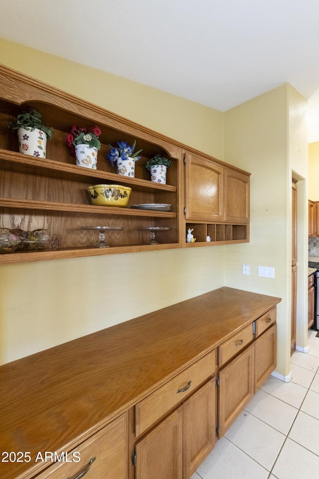 kitchen with light tile patterned flooring